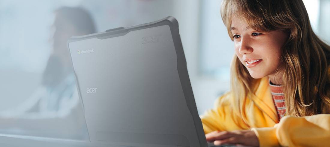 Young girl in school wearing yellow jacket completing an assignment on her Acer Chromebook